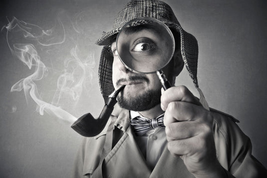 Investigator with a pipe and magnifying glass