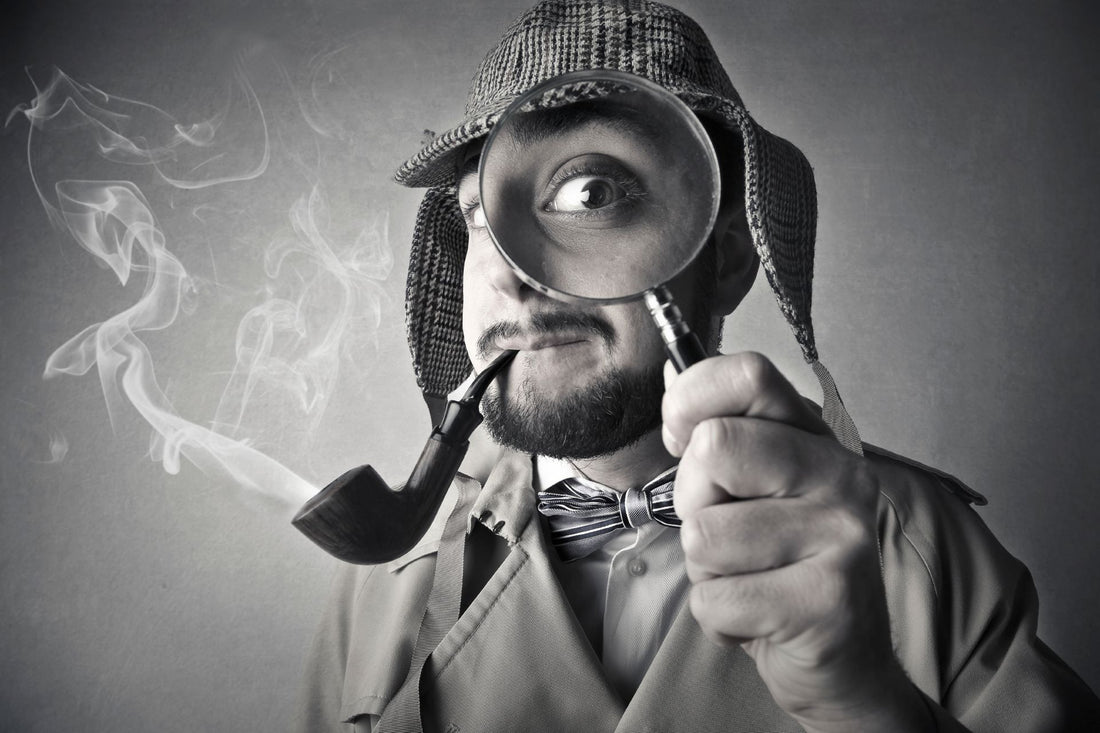 Investigator with a pipe and magnifying glass